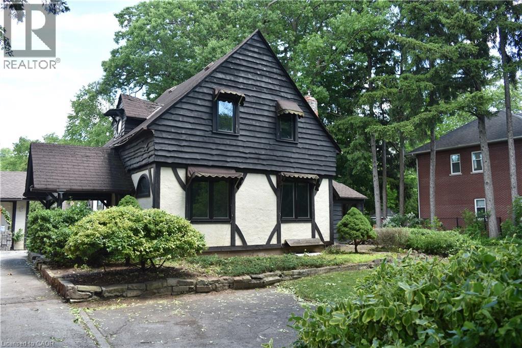 Tudor-style exterior with dark shingle siding and contrasting white stucco