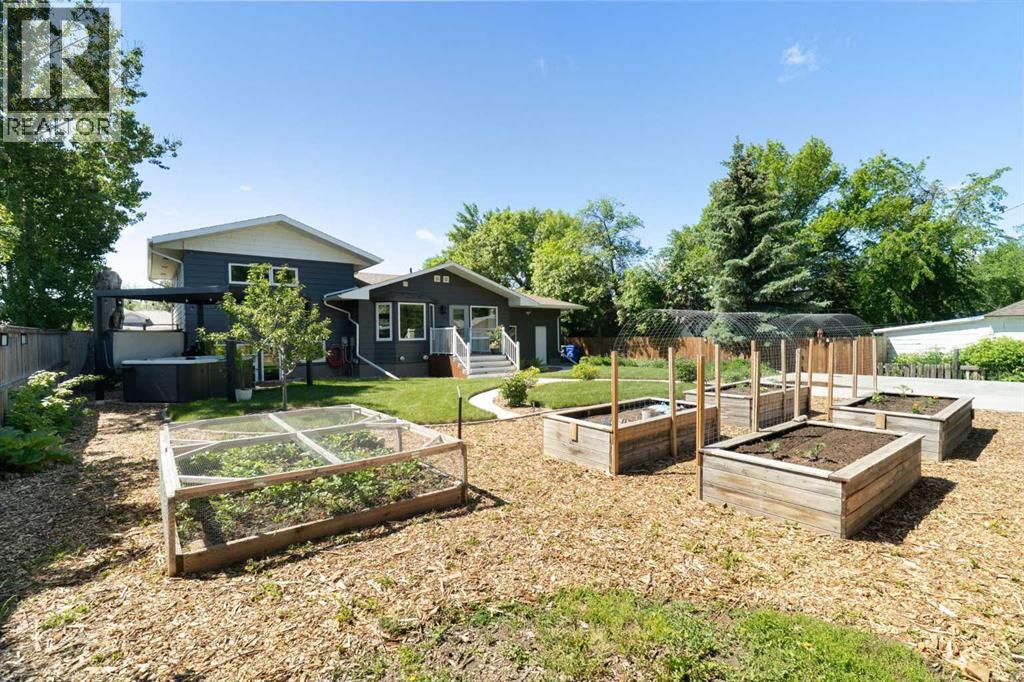 The true luxury of a large lot: a garden area, fruit trees, perennial blooms, hot tub, and room for a second garage