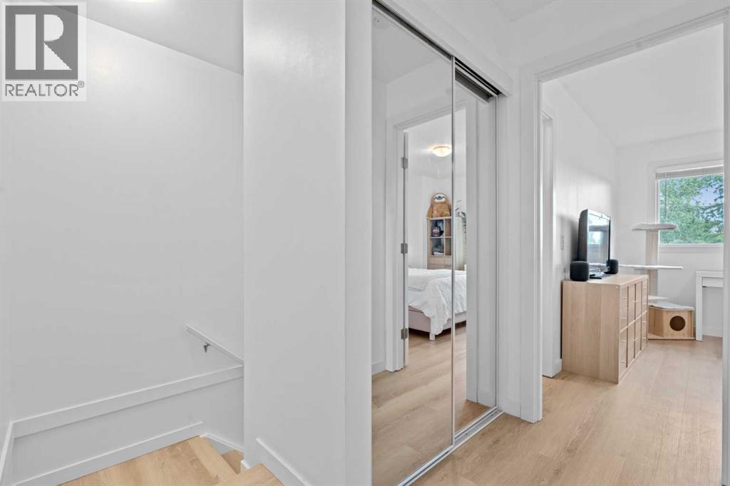 Upper level landing with mirrored linen closet