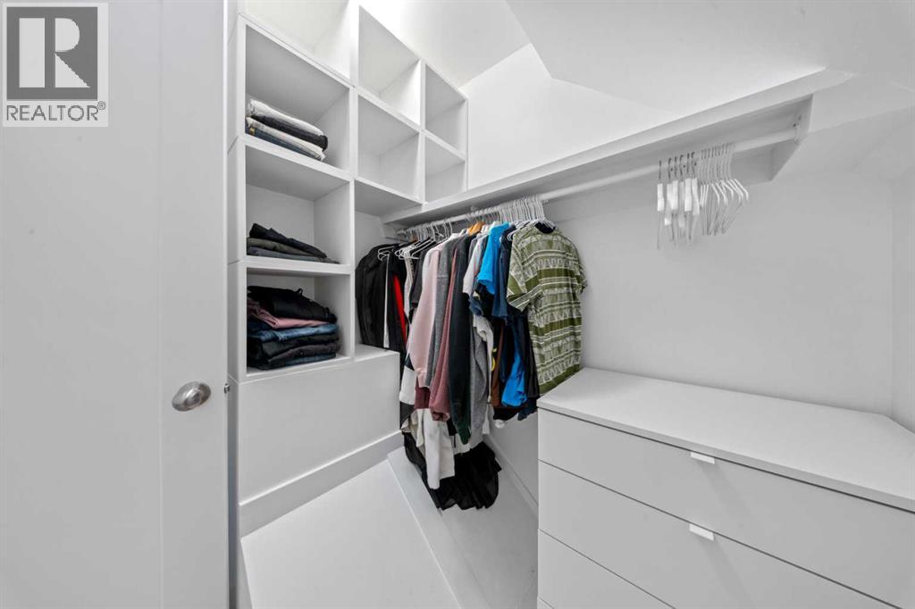 Primary walk in closet with shelving