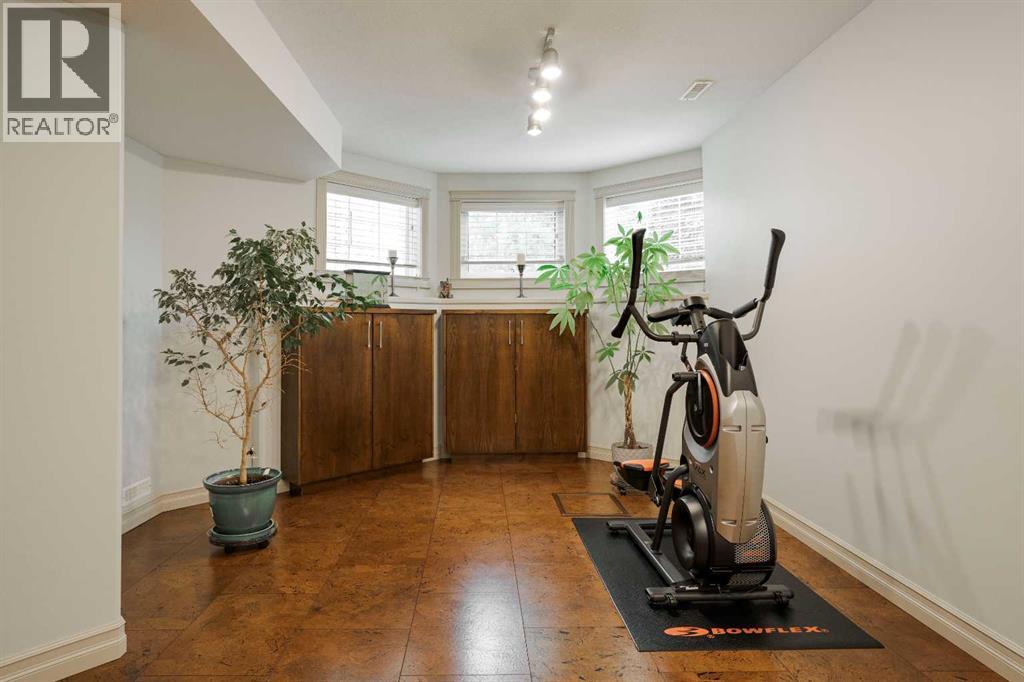 Basement living room with cohesive built in cabinets and cork tile flooring