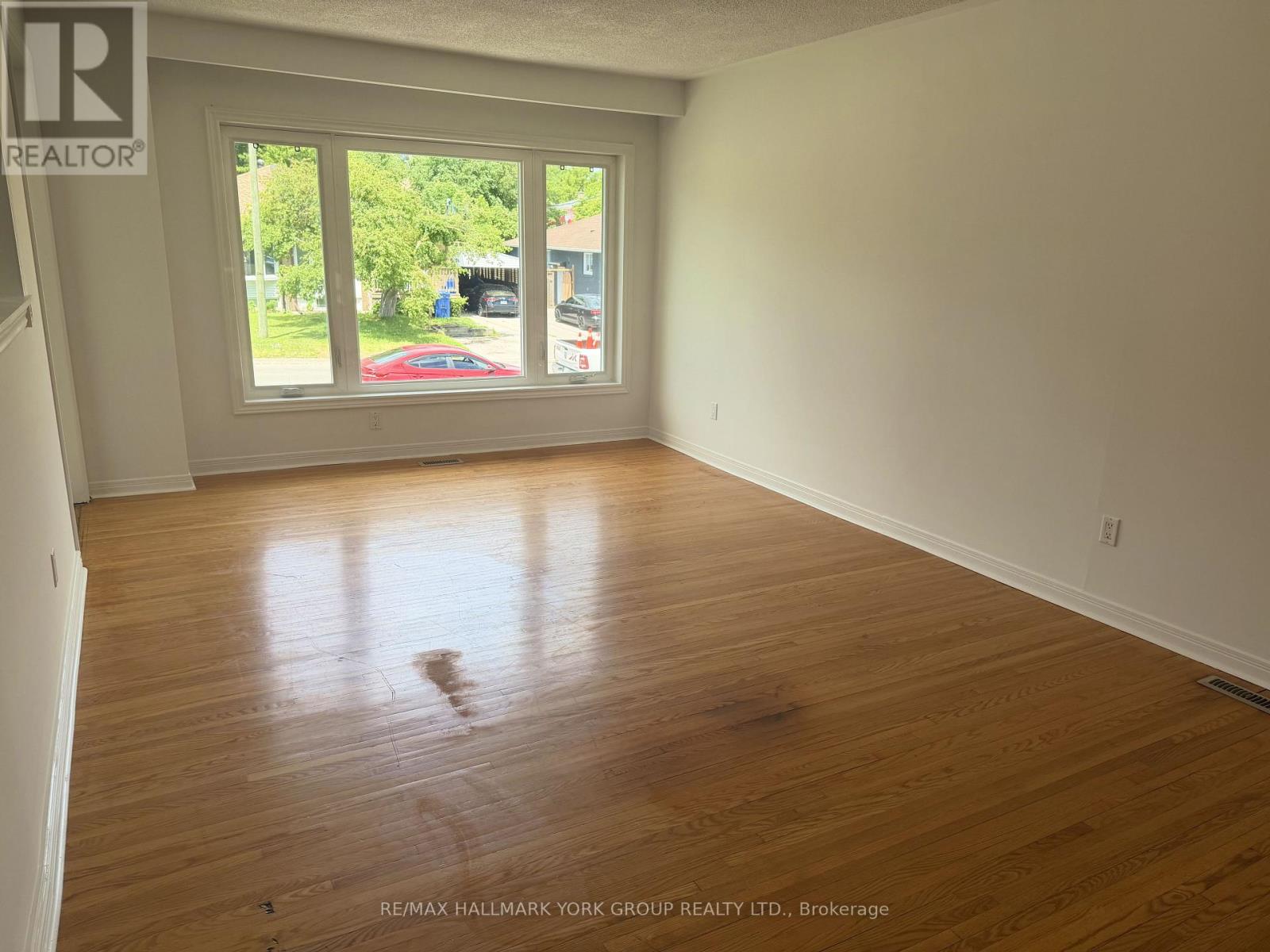 hardwood floors and a large window