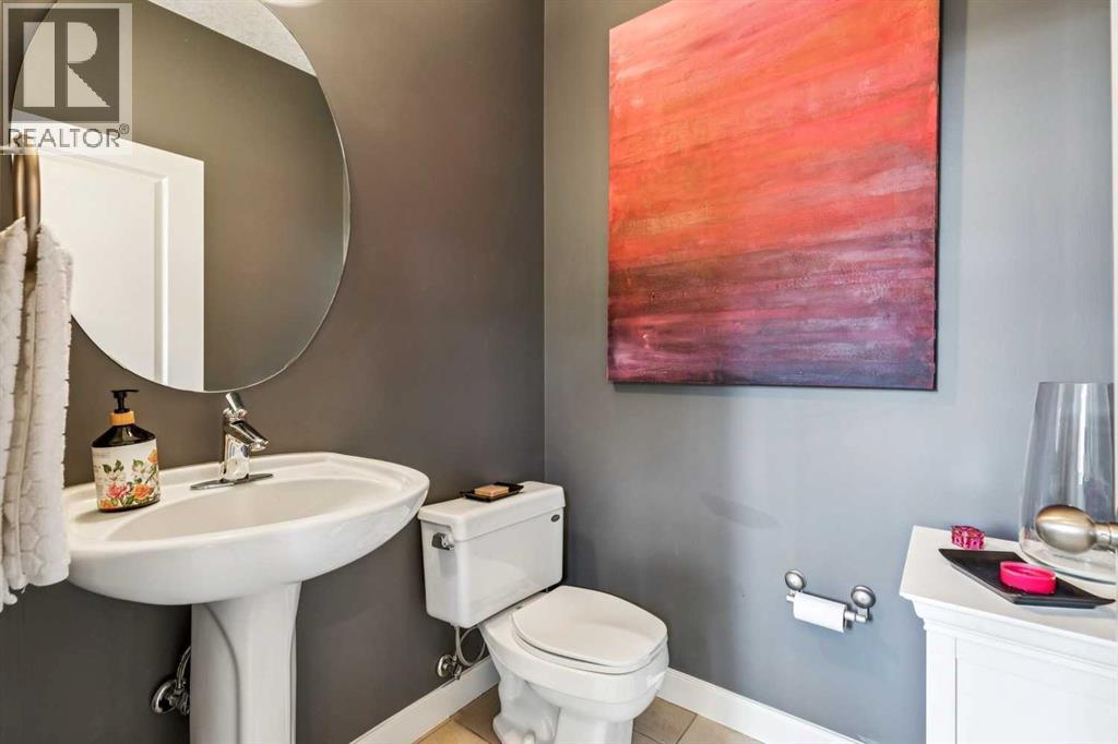 2pc powder room is discreetly located just off the mudroom/back entry