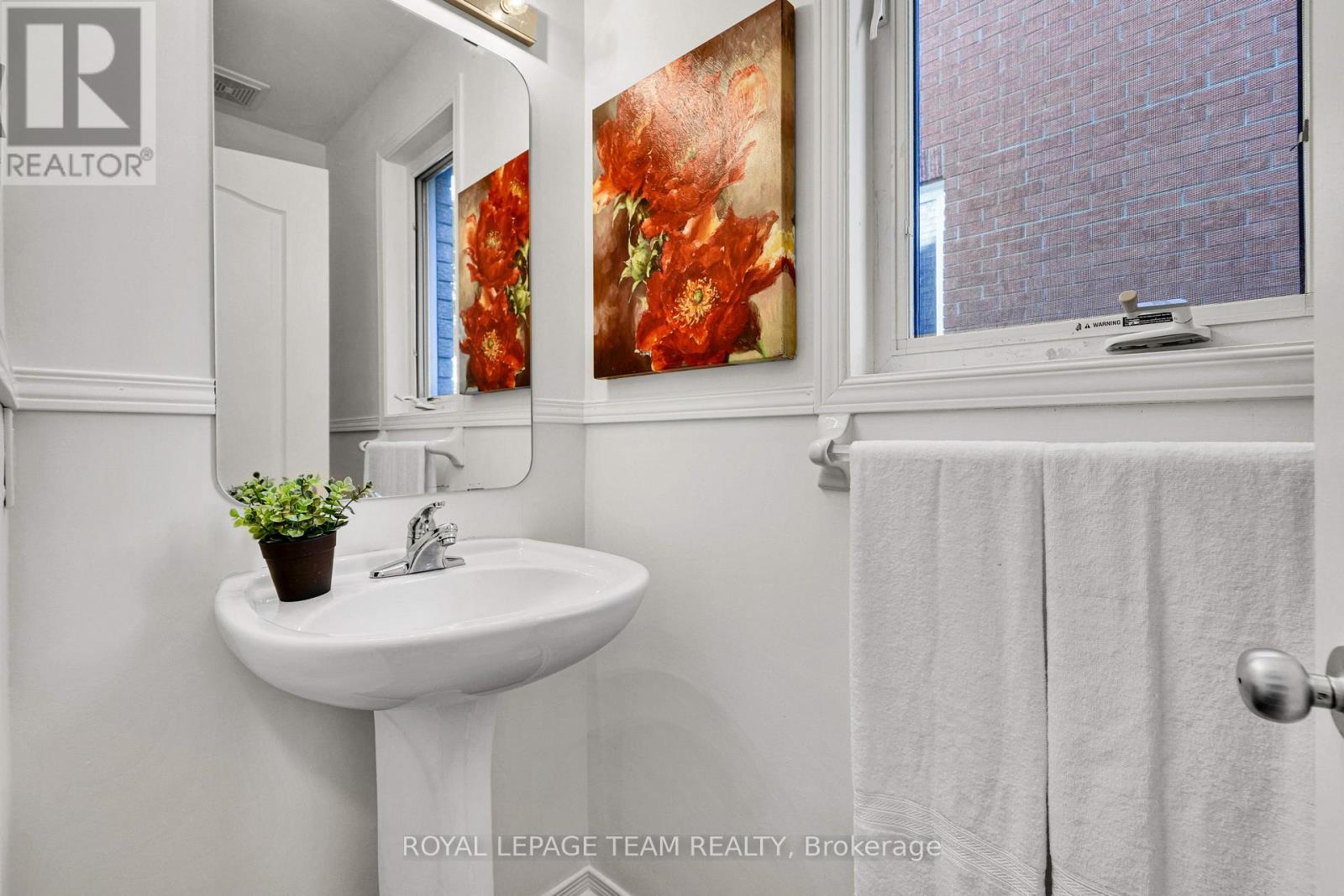MAIN FLOOR POWDER ROOM OFF HALL.
