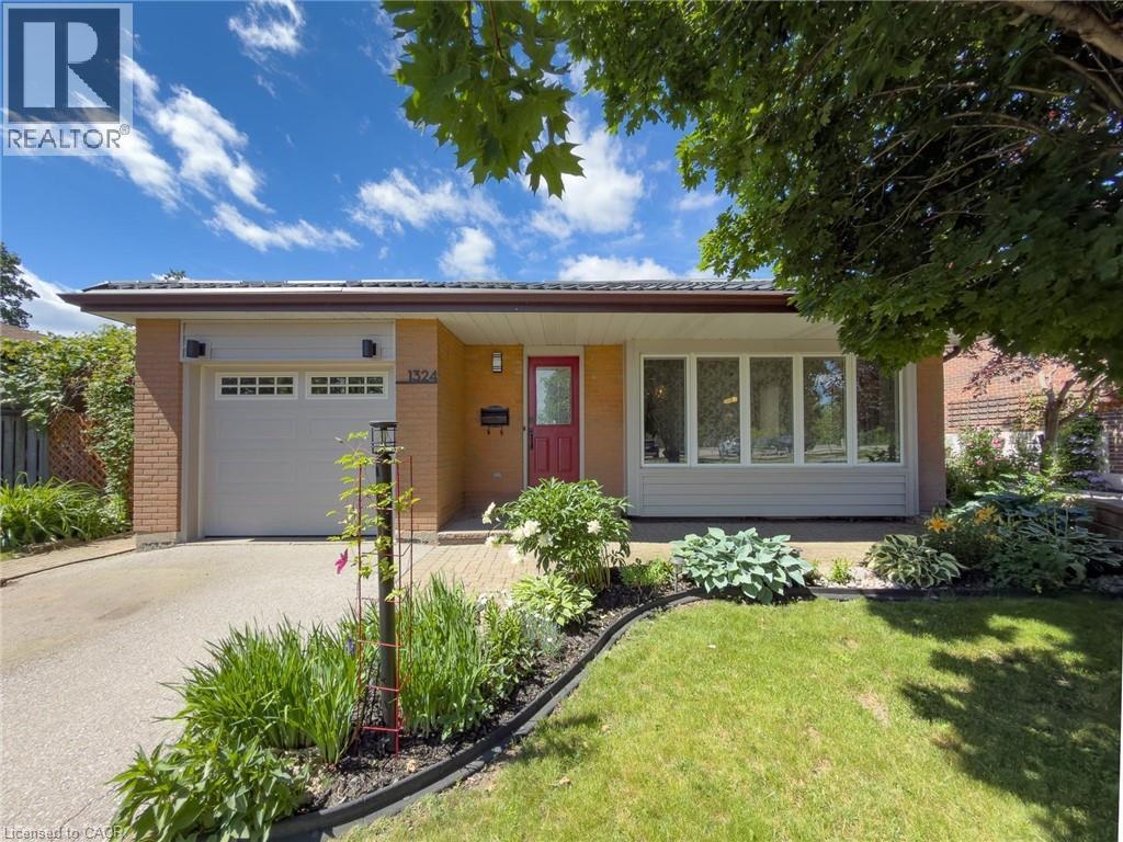 Brick exterior with an attached garage, featuring a red entry door and a large picture window