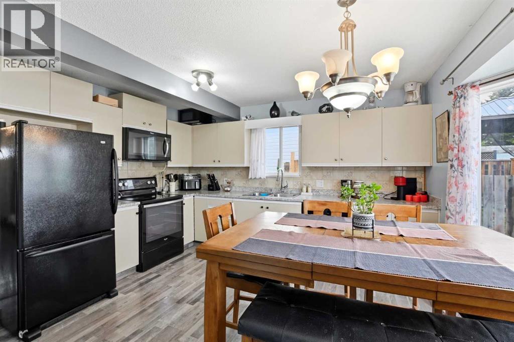 The kitchen and dining area overlook the sunny south-facing backyard through a charming bay window