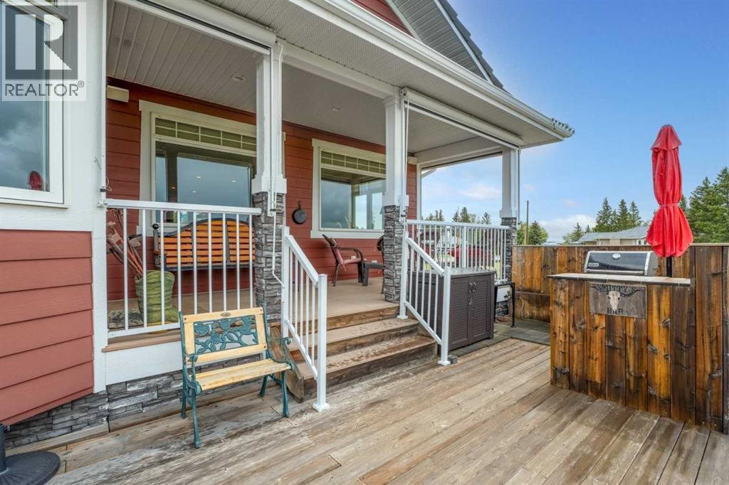 Enjoy the back covered porch watching the storms roll in.  This space includes pull down blinds for shade when desired.  There is a gas line on the front porch and 2 in the back deck area