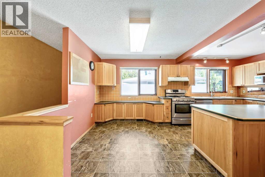 Designed with functionality in mind, the large kitchen includes extensive storage, a central island, and plenty of workspace for everyday living