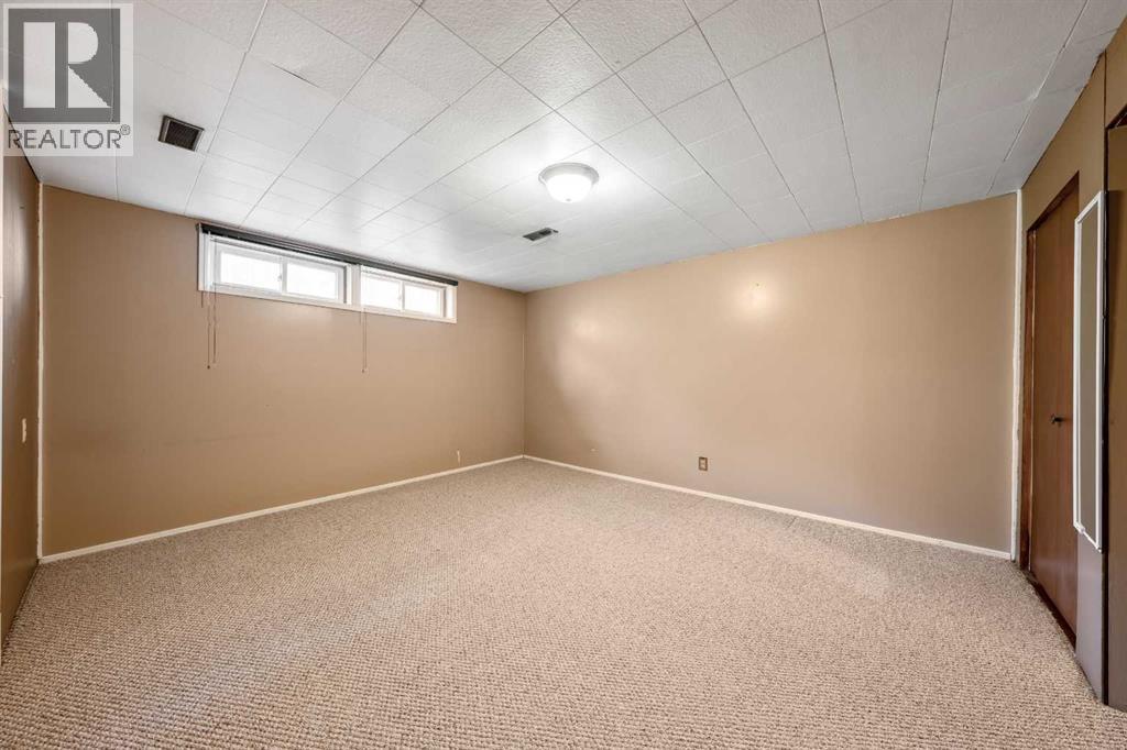 Spacious fourth bedroom with neutral tones, and ample room for family or guests