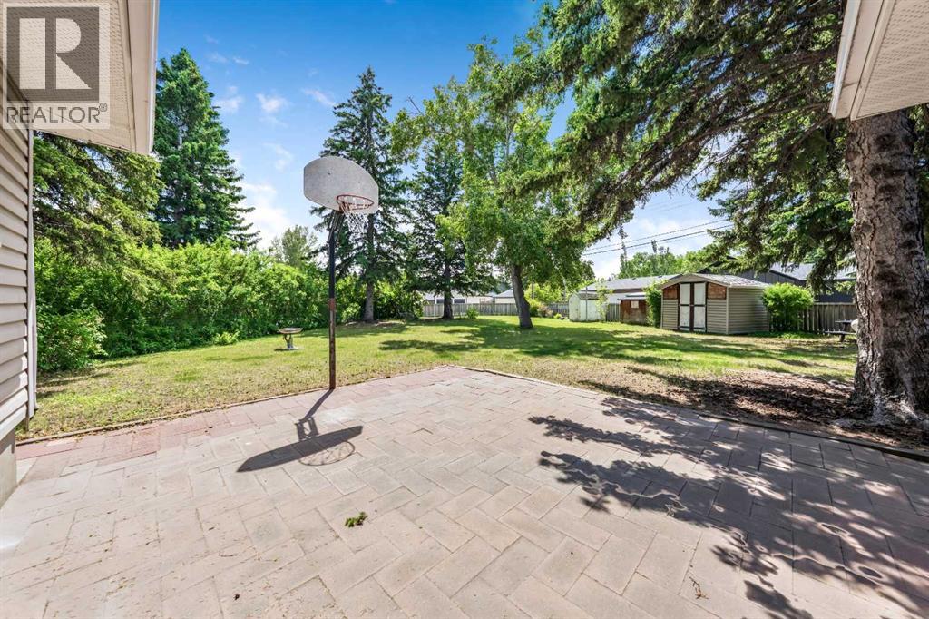 Large interlocking stone patio provides the perfect setting for summer BBQs, outdoor dining, and relaxing while overlooking the backyard