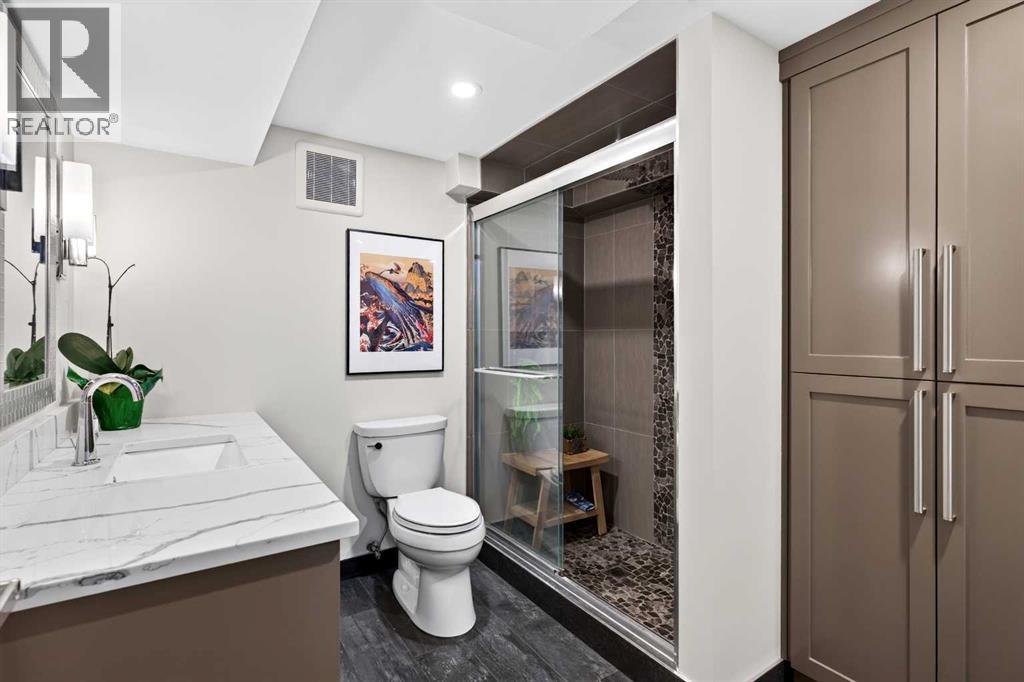 Basement bathroom features heated floors, tiled shower and tons of storage space!