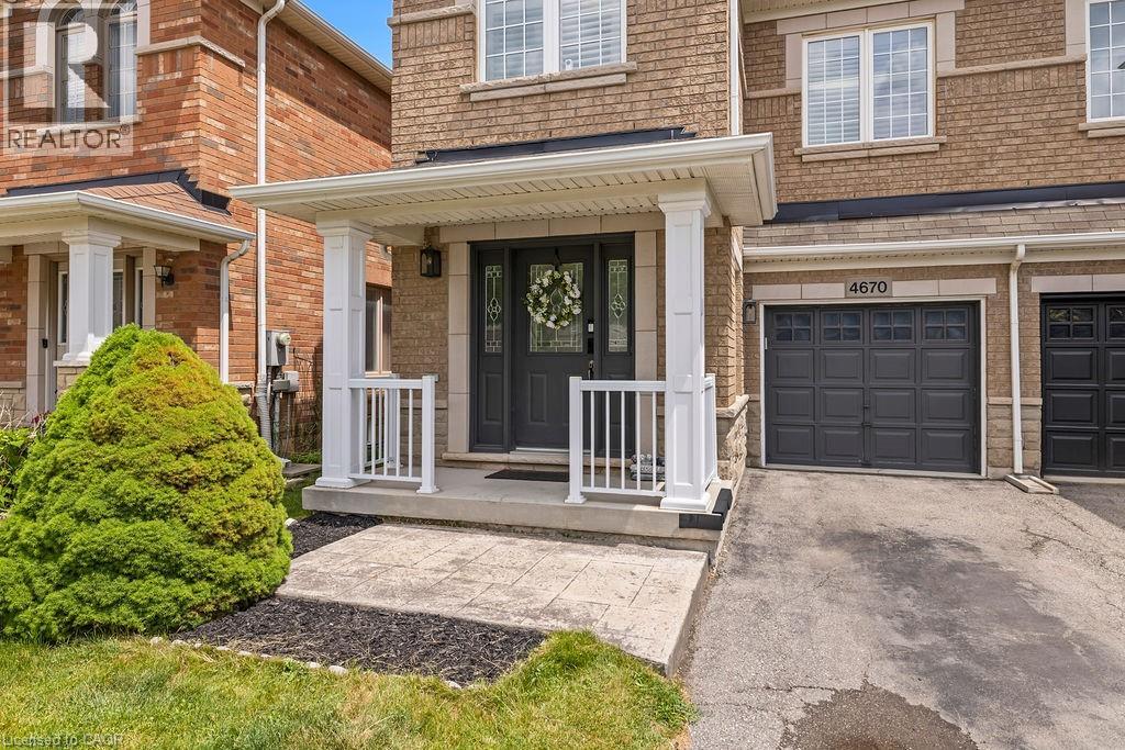 Brick facade with stone accents and white trim