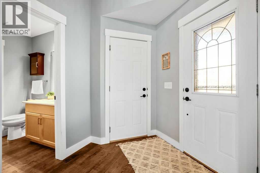 A bright and spacious entry way with vaulted ceilings as you enter.  Gorgeous vinyl plank flooring was installed a few years ago on the main level