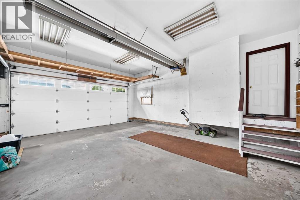 The heated, attached double garage features a radiant tube heater and a 220-volt plug, offering an ideal setup for year-round projects