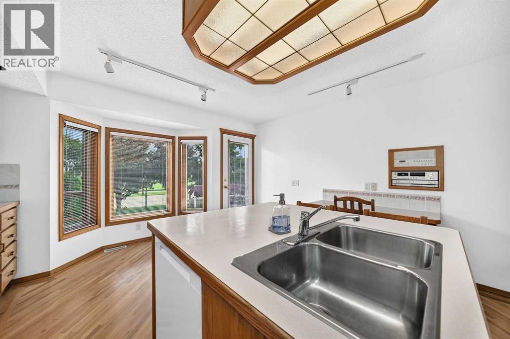 Bright breakfast nook area ideal for casual dining with a garden door that offers convenient access to a mature backyard