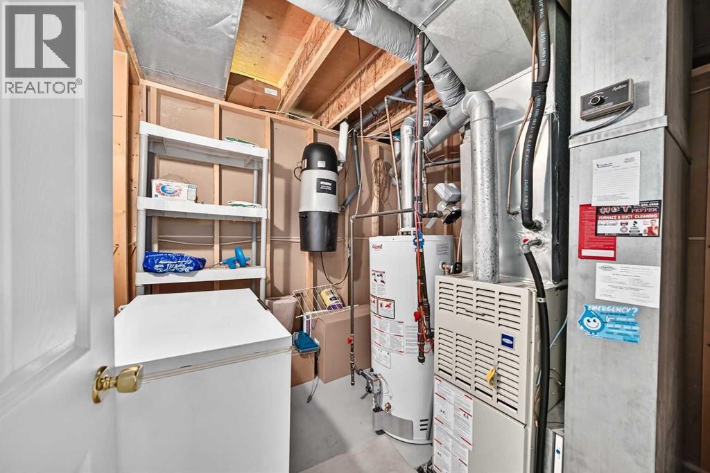 The lower-level utility room. Note the A/C lines in the sheet metal above the furnace. The storage shelf with some filters, some tools and the freezer can be included