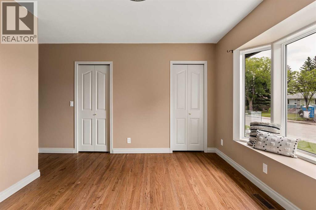 Second of two beds on main floor with expansive bay window. Perfect for an office space