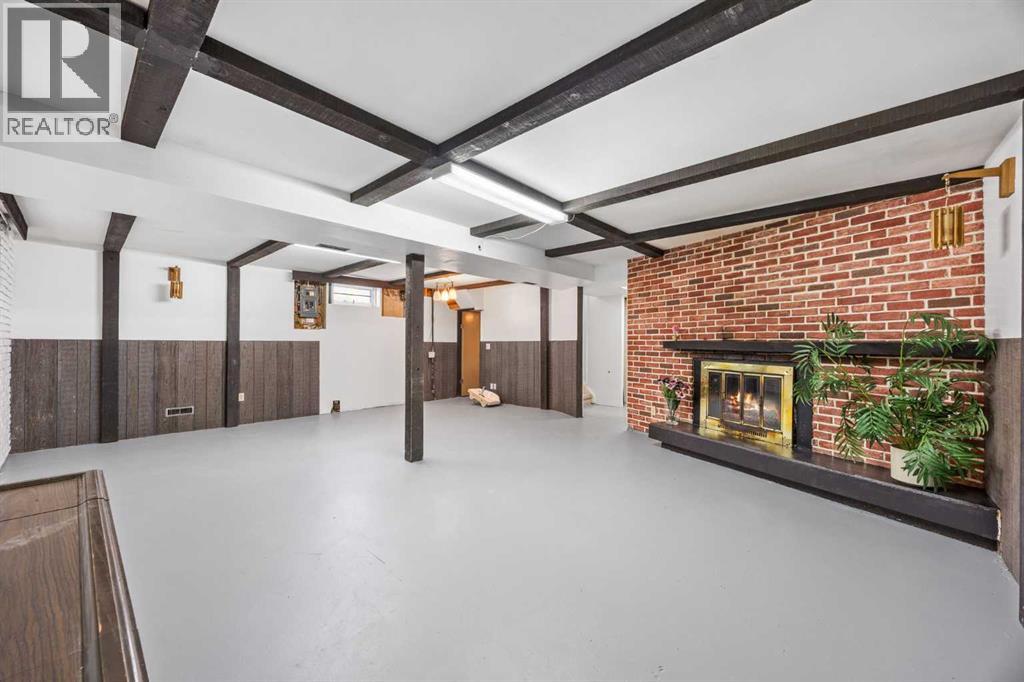 Huge open rec room downstairs with wood beam accents