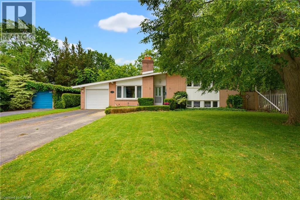 Mid-century modern residence featuring a brick facade, white trim, and a prominent front lawn