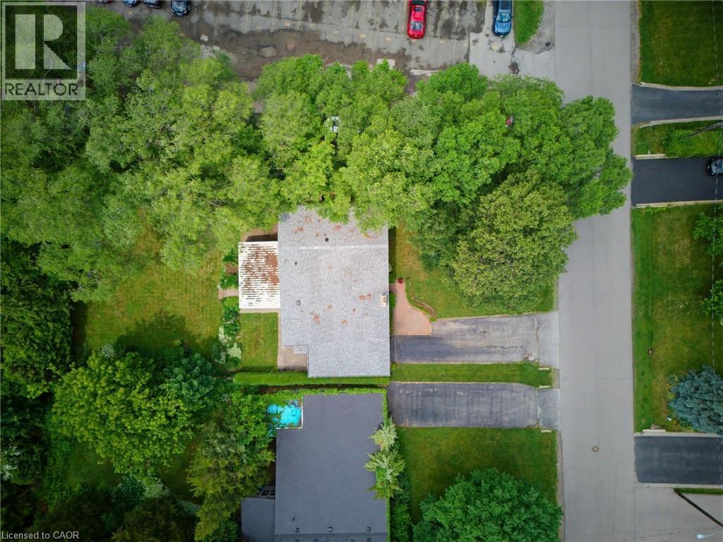 Aerial perspective showcasing a property surrounded by mature trees
