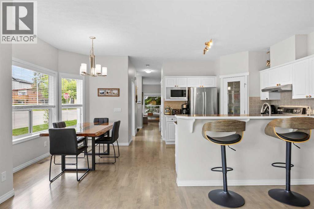 An open sightline showcases how effortlessly the dining, kitchen, and living areas connect for everyday living and hosting alike