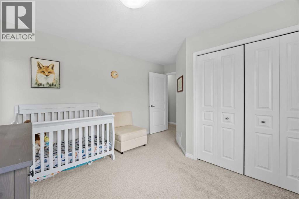 A generous second bedroom with double closet and large windows, easily suited as a child's room or guest space