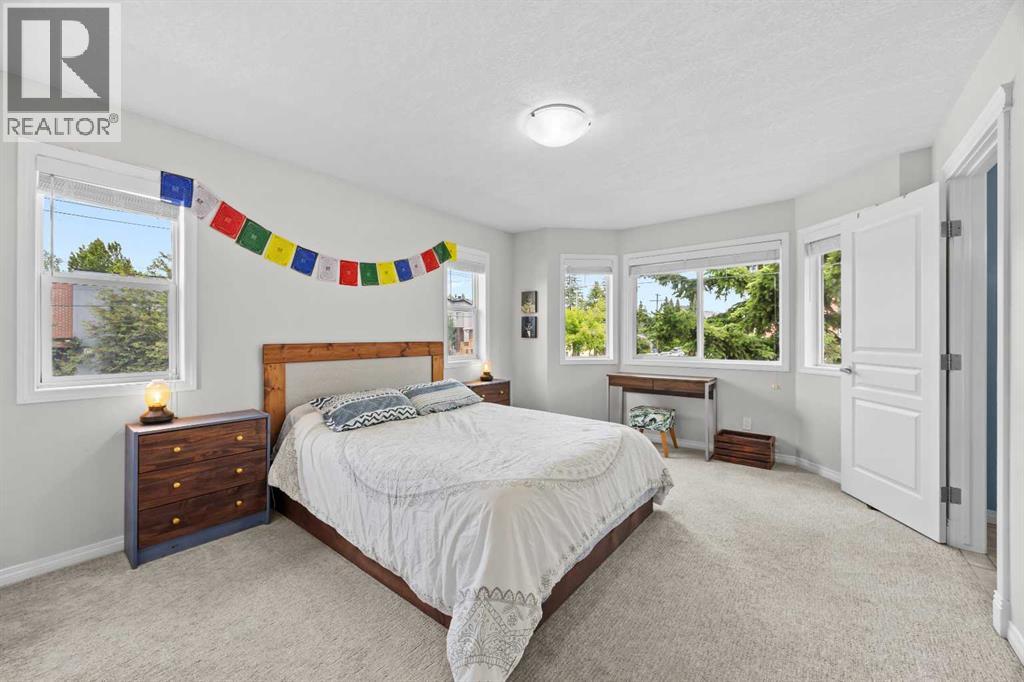 The spacious primary bedroom enjoys a bright bay window, plush new carpet, and its own private ensuite