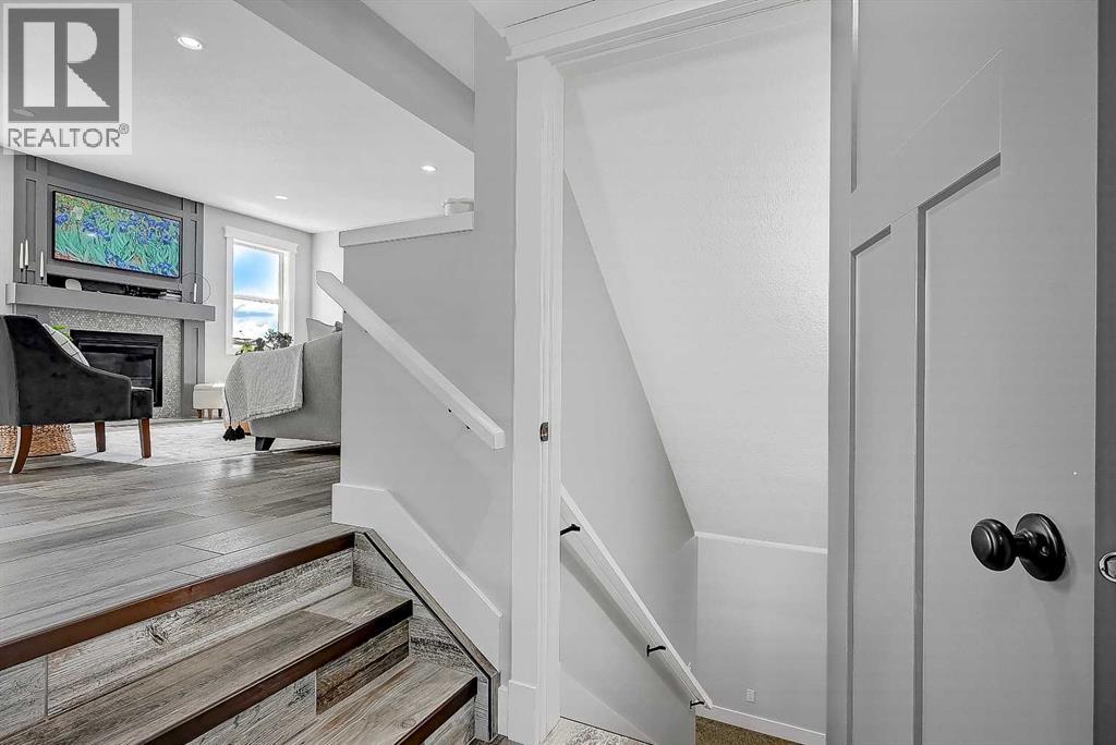 Stairway to Garage Entry, 1/2 Bath & Basement