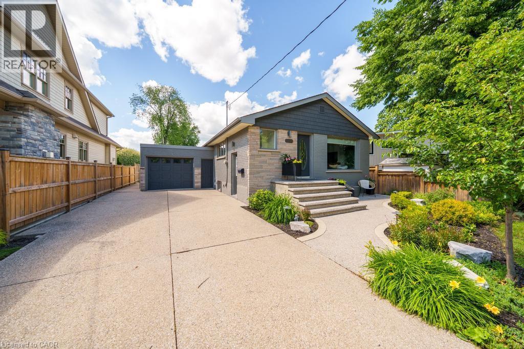 Expansive front lawn with mature trees and established landscaping