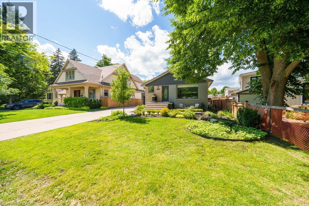 Expansive front lawn with mature trees and established landscaping
