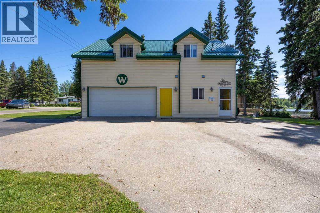 HEATED DOUBLE GARAGE WITH LAUNDRY PLUS EXPOSED AGGREGATED CONCRETE DRIVEWAY