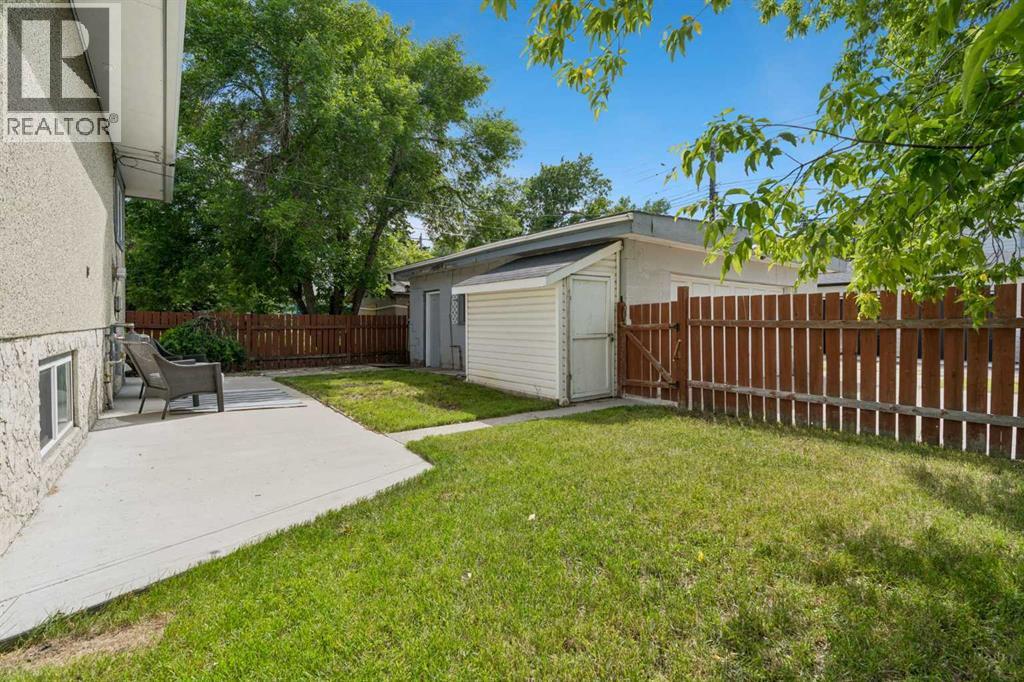 Yard with new concrete patio and storage shed