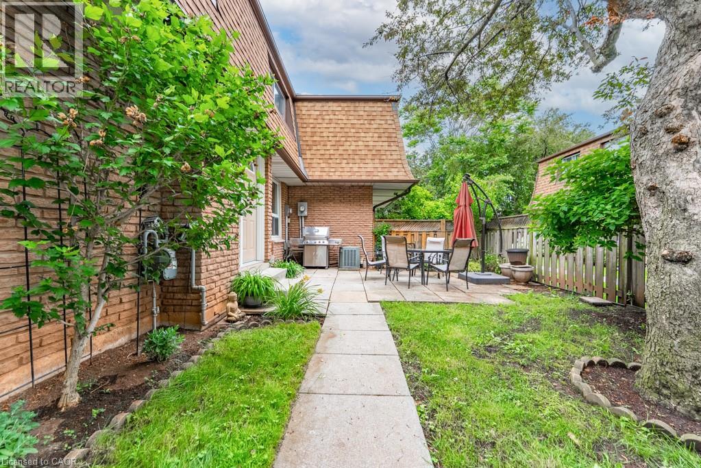 Private backyard featuring a paved patio and a grass area