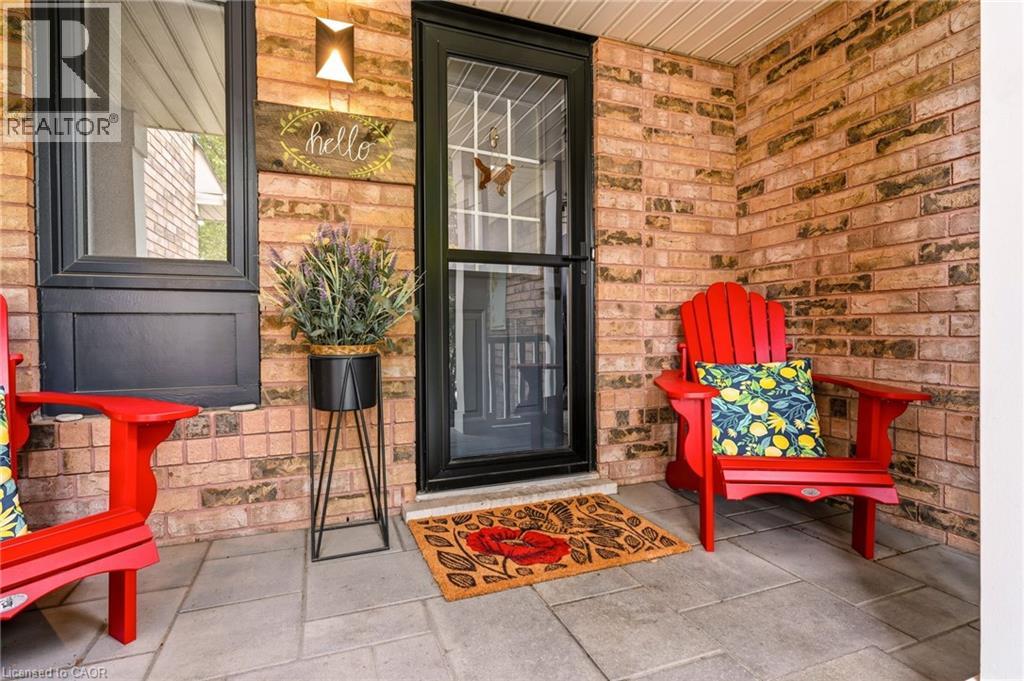 Brick exterior featuring dark-framed windows and a complementary dark-framed storm door
