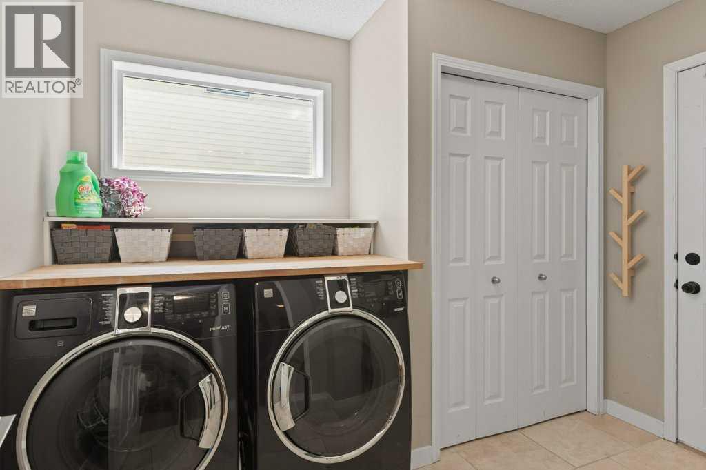 Practical main floor laundry and mudroom with additional storage and garage access