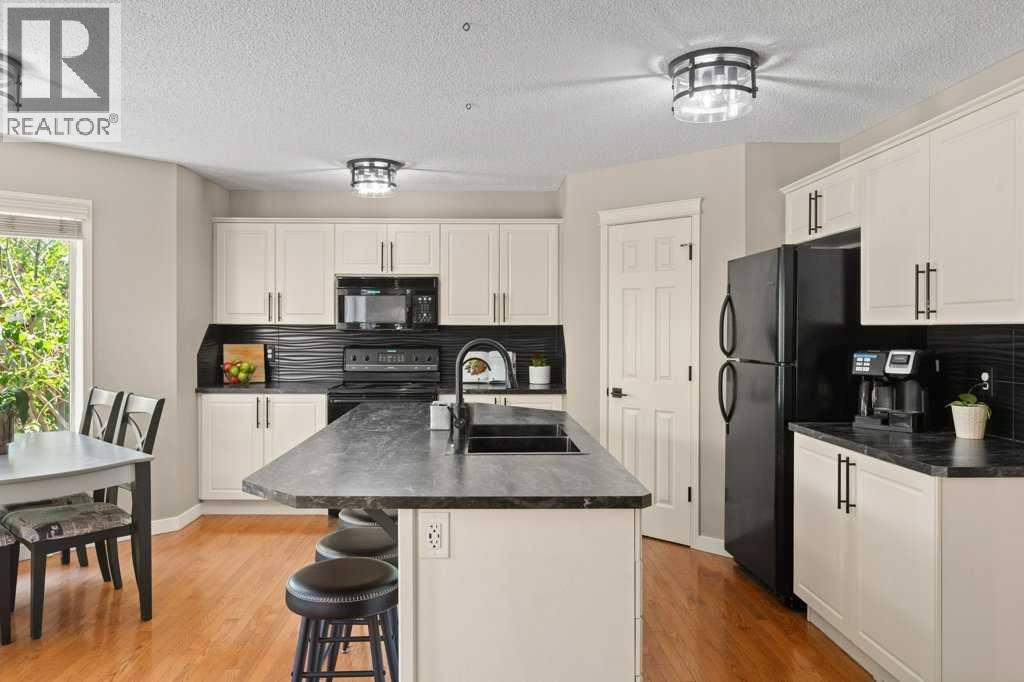 Wellappointed kitchen featuring extensive cabinetry, modern finishes, and a walk-in pantry