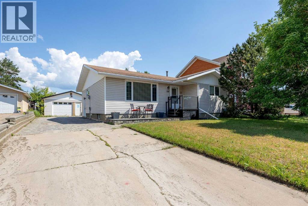Front view of home with detached garage down the side