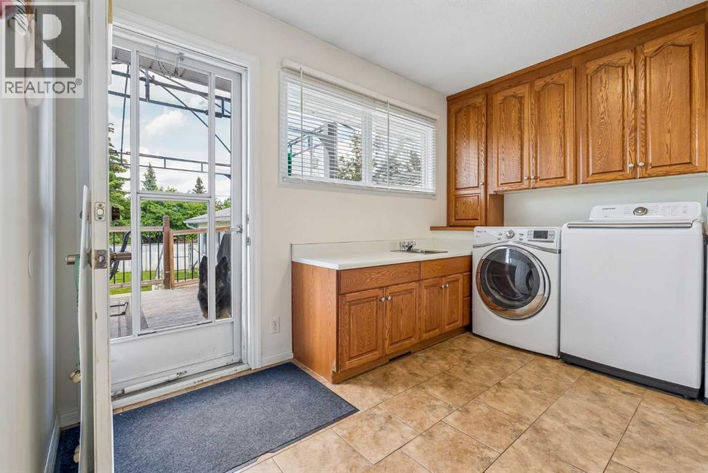 Laundry room with back door to deck