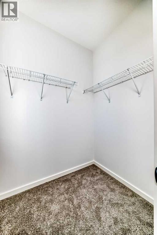 Bedroom Two Walk-In Closet • PLEASE NOTE: Photos are of a DIFFERENT Spec Home of the same model – fit and finish may differ. Interior selections and floorplans shown in photos