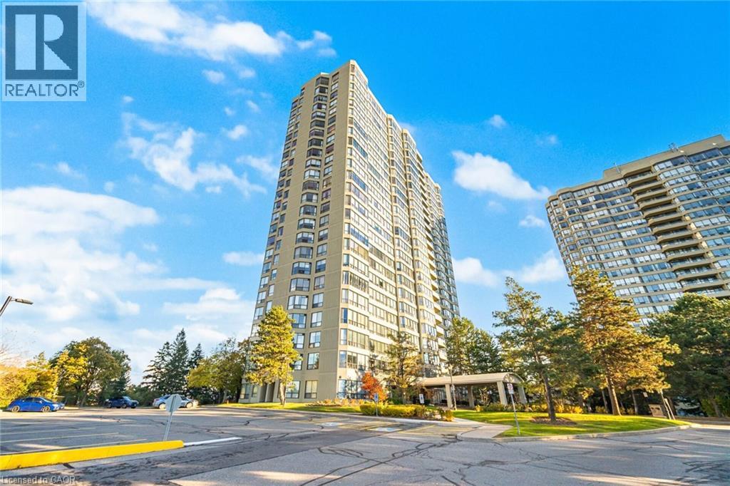 Expansive high-rise building featuring numerous balconies and a covered entrance