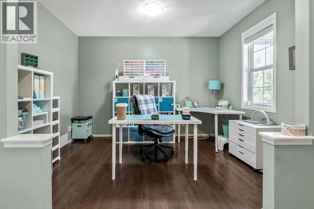 Hardwood floors and large windows make this versatile space ideal as a formal dining room, home office, or sitting room