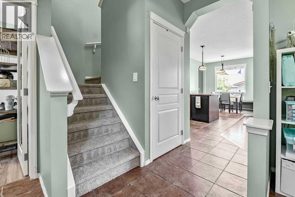 The central staircase leads to a thoughtfully designed upper level with three bedrooms, two full bathrooms, and a convenient laundry room