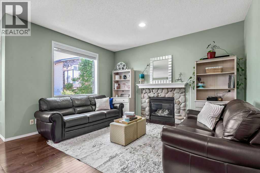 Gather around the cozy gas fireplace while oversized windows fill the space with natural light