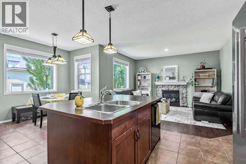 The open-concept layout keeps everyone connected, seamlessly blending the kitchen, dining area, and family room