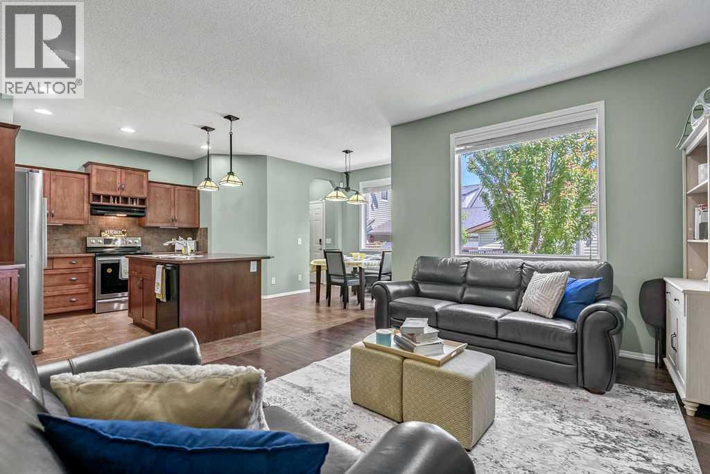 Warm hardwood floors and a beautiful stone-surround gas fireplace create an inviting space to relax or entertain