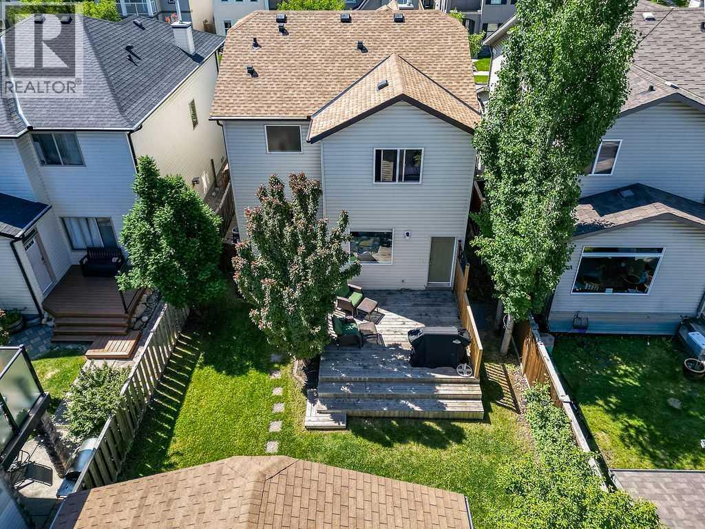 Enjoy a bird's-eye view of the backyard, deck, and oversized garage, showcasing the property's functional outdoor layout