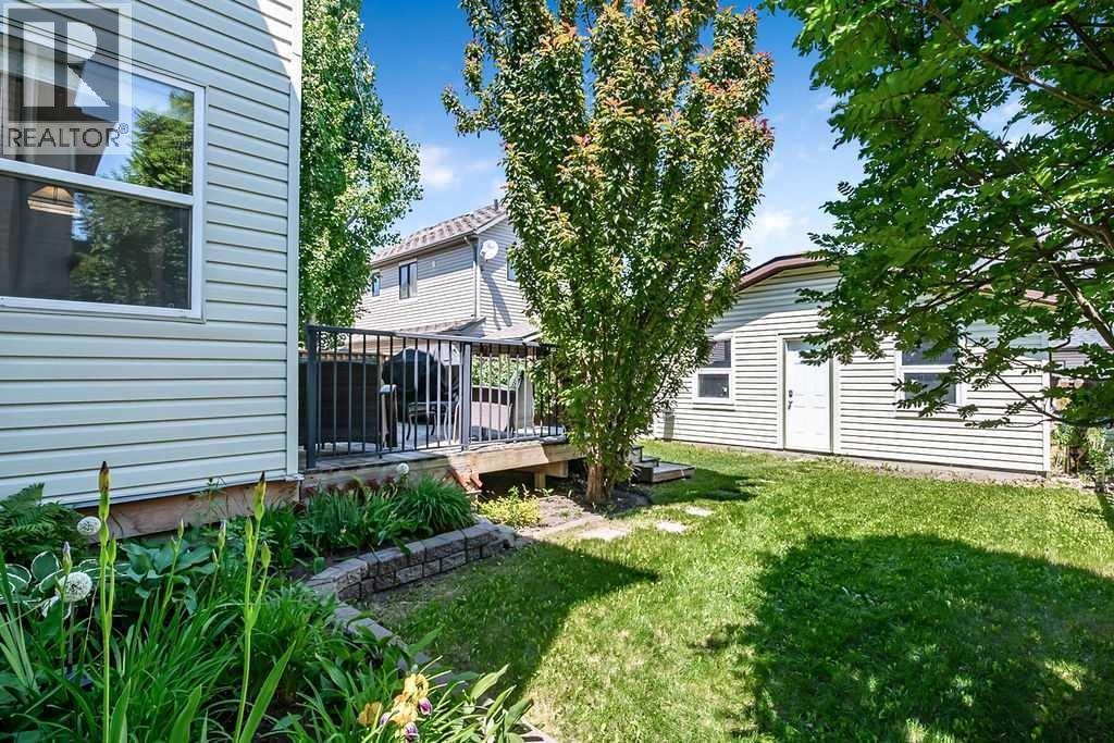 The oversized detached double garage provides plenty of space for vehicles, storage, and projects, with additional room beside it