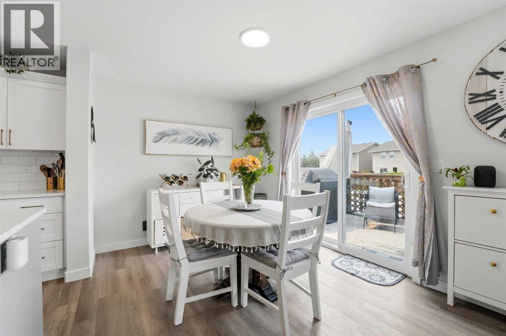 The spacious dining area overlooks the backyard through sliding glass patio doors