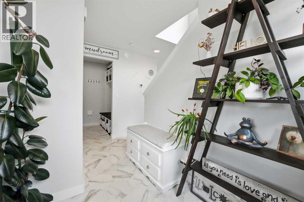 The welcoming front entry features a coat closet and space for a bench