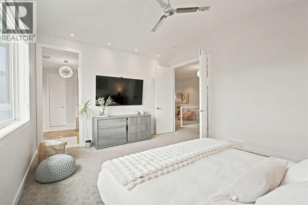 Primary bedroom with vaulted ceilings